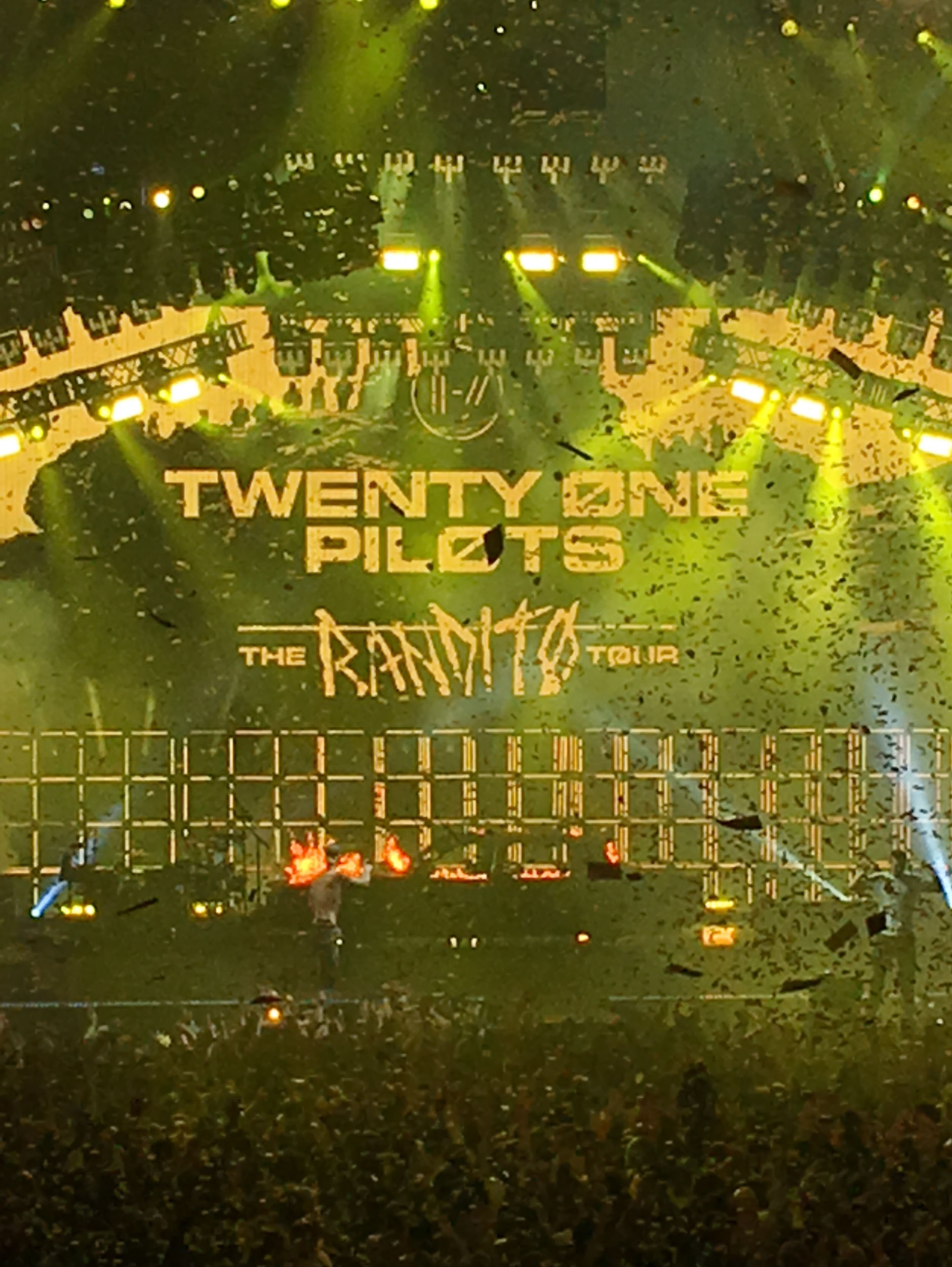 "Twenty One Pilots The Bandito Tour" written across the back wall of the stage and yellow confetti flying around